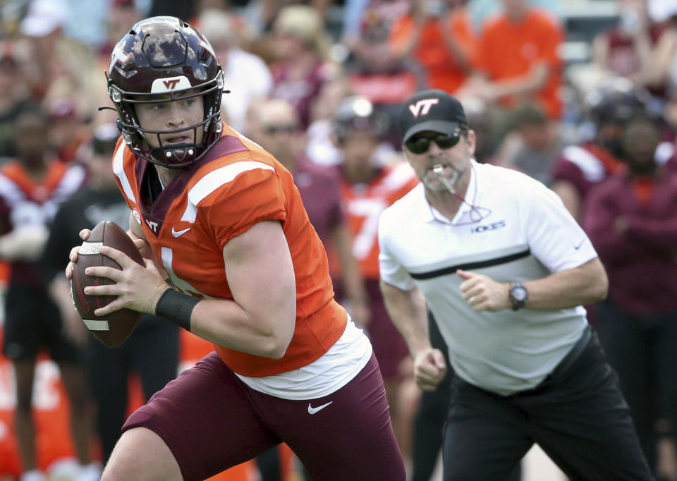 FILE - Virginia Tech quarterback Grant Wells (6) rolls out while observed by head coach Brent Pry during the team's spring NCAA college football game in Blacksburg, Va., Saturday, April 15, 2023. Virginia Tech opens their season at home against Old Dominion on Sept. 2. (Matt Gentry/The Roanoke Times via AP, File)