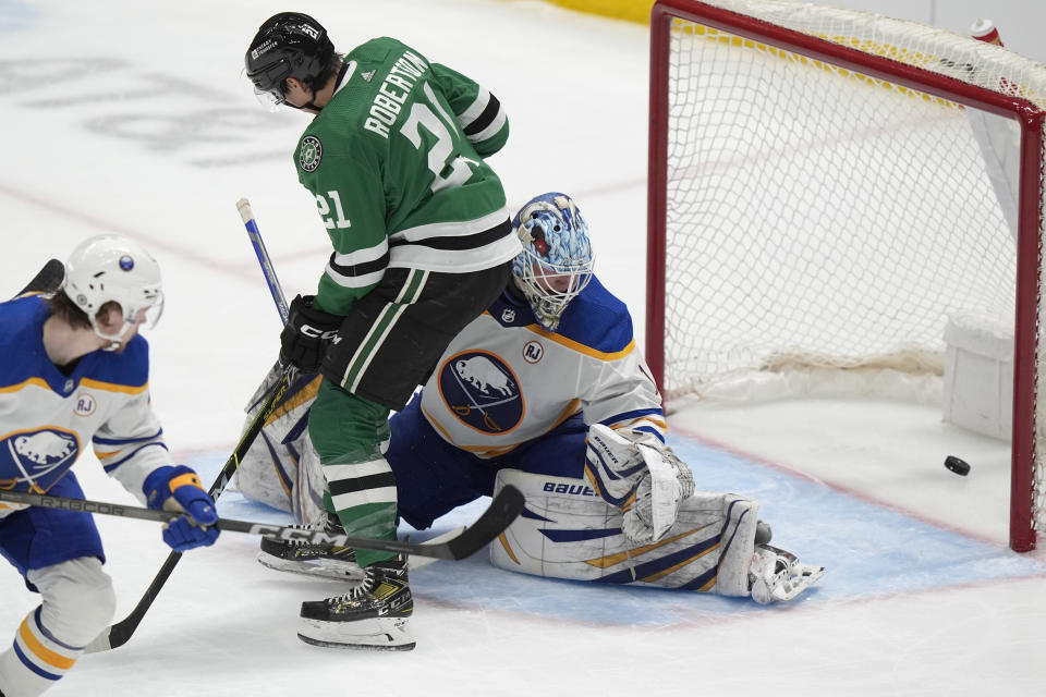 Dallas Stars left wing Jason Robertson (21) positions as Buffalo Sabres goaltender Ukko-Pekka Luukkonen (1) allows a goal by Stars' center Joe Pavelski during the second period an NHL hockey game in Dallas, Tuesday, April 9, 2024. (AP Photo/LM Otero)