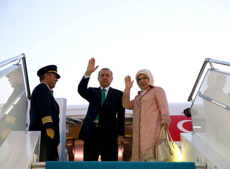 Turkish President Tayyip Erdogan, accompanied by his wife Emine Erdogan, waves as he departs for Warsaw to attend a NATO summit, in Istanbul, Turkey, July 7, 2016. Kayhan Ozer/Presidential Palace/Handout via REUTERS