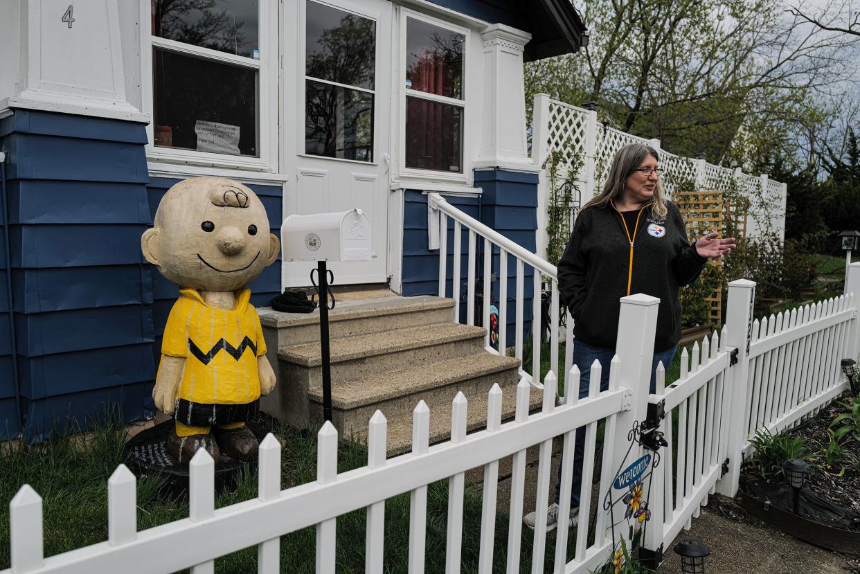 Jennifer Kalacanic from Lansing talks about her heavy wooden sculpture of Charlie Brown she had commissioned a couple of years ago Thursday, April 20, 2023. She is selling the statue and says she has seen some interest in it.