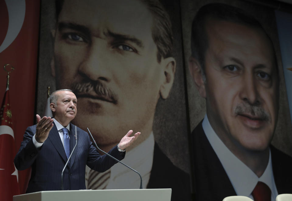 Turkey's President Recep Tayyip Erdogan addresses his ruling party members, in Ankara, Turkey, Friday, July 26, 2019. Erdogan says Turkey is determined to destroy what he called a "terror corridor" in northern Syrian regardless of whether or not Turkey and the United States agree on the establishment of a safe zone. Turkish and U.S. officials have been holding talks for a safe zone east of the river Euphrates to address Turkey's security concerns.(Presidential Press Service via AP, Pool)