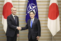 NATO Secretary-General Jens Stoltenberg, left, shakes hands with Japan's Prime Minister Fumio Kishida on Tuesday, Jan. 31, 2023, in Tokyo. (Takashi Aoyama/Pool Photo via AP)