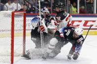 Canada's Emily Clark (26) and United States' Emily Matheson (8) collide in front of goalie Alex Cavallini during the second period of a rivalry series women's hockey game in Hartford, Conn., Saturday, Dec. 14, 2019. (AP Photo/Michael Dwyer)