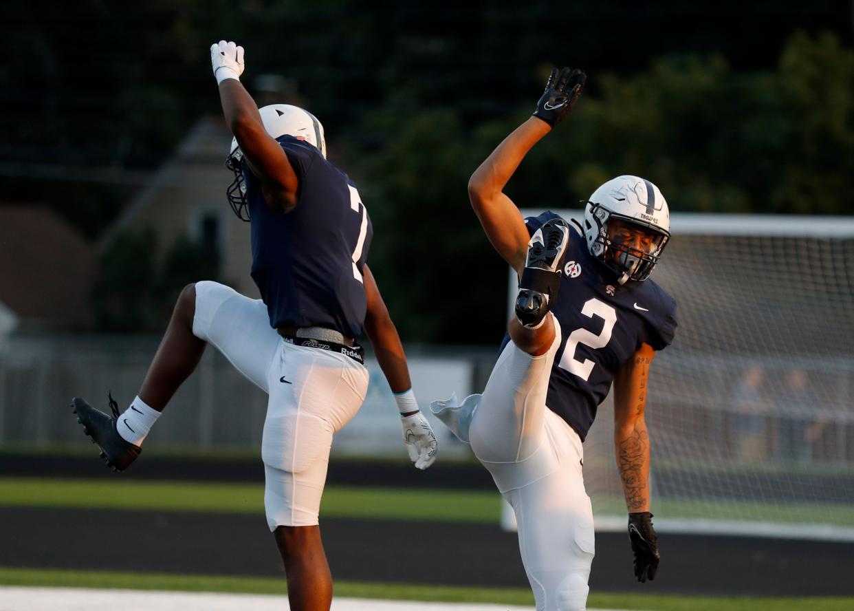 East Lansing's Evan Boyd, right, and Pryderick Achuonjei celebrate Boyd's touchdown against DeWitt, Friday, Sept. 16, 2022, in East Lansing, Mich. East Lansing won 36-30.