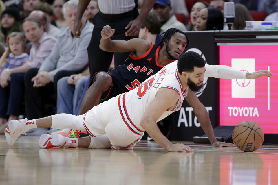 Houston Rockets guard Fred VanVleet, right, dives for a loose ball against Toronto Raptors guard Immanuel Quickley, left, during the first half of an NBA basketball game Friday, Feb. 2, 2024, in Houston. (AP Photo/Michael Wyke)