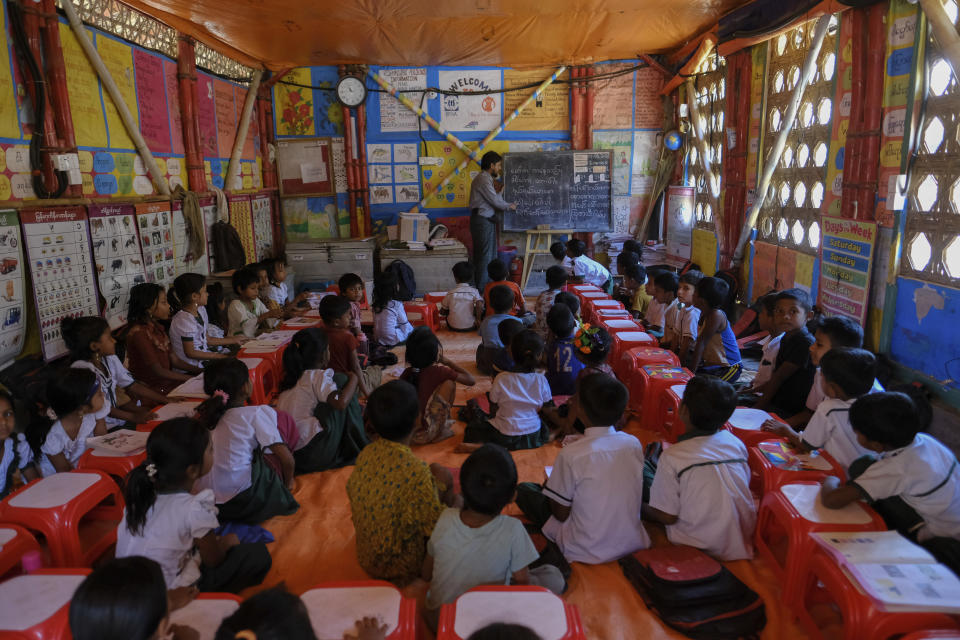 Rohingya refugee children sit together in the classroom of a school at a refugee camp in the Cox's Bazar district of Bangladesh, on March 9, 2023. (AP Photo/Mahmud Hossain Opu)