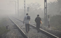 <p>GHAZIABAD, INDIA NOVEMBR 17: Men walking along a railway track amid dense smog at Masuri, on November 17, 2021 in Ghaziabad, India. (Photo by Sakib Ali/Hindustan Times via Getty Images)</p> 