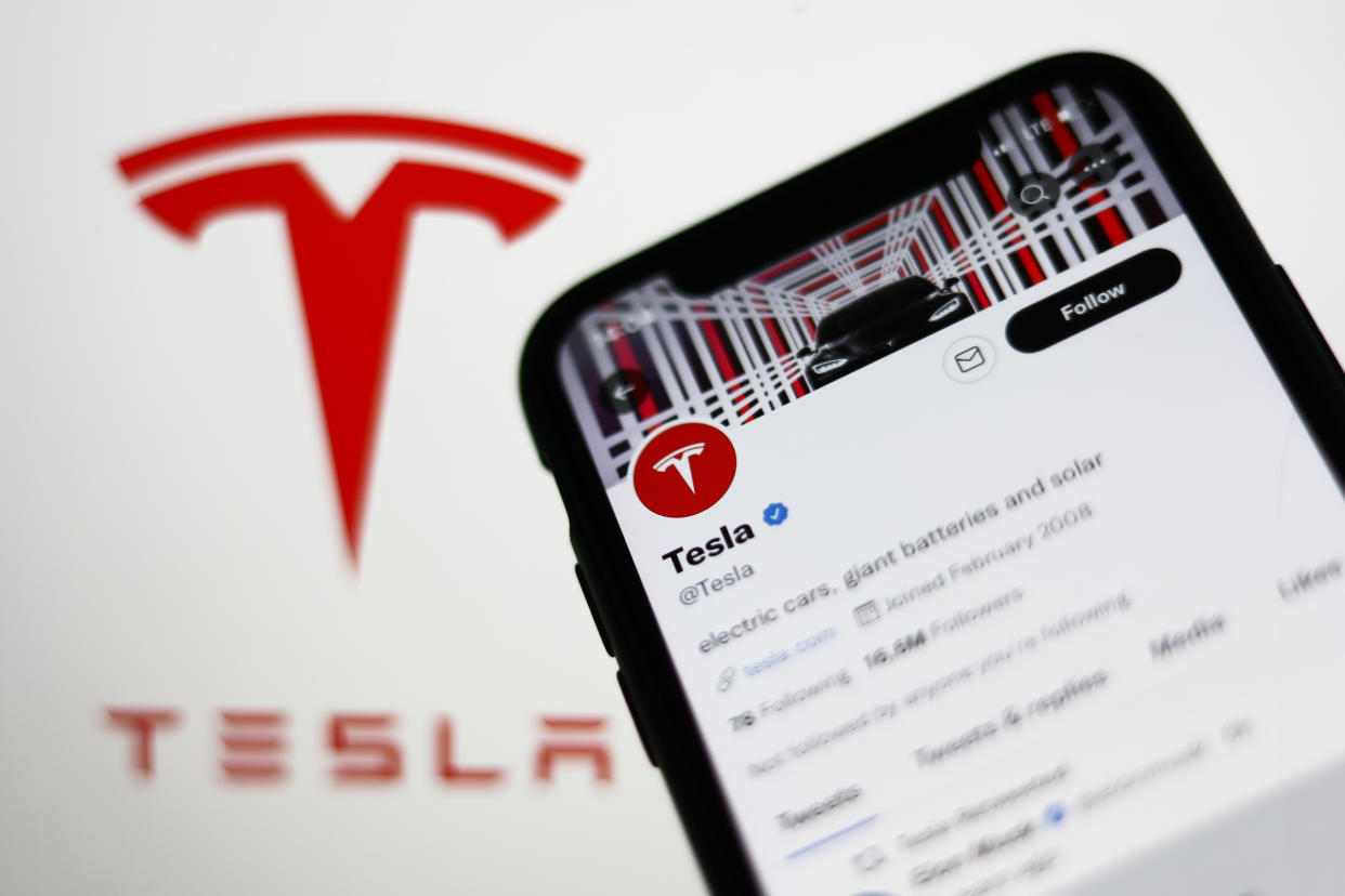 Twitter account of Tesla displayed on a phone screen and Tesla logo displayed in the background are seen in this illustration photo taken in Krakow, Poland on August 10, 2022. (Photo by Jakub Porzycki/NurPhoto via Getty Images)