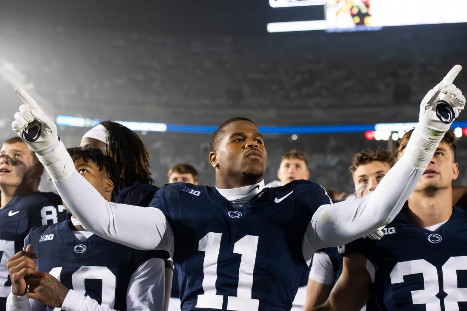 Penn State linebacker Abdul Carter (11) pretends to conduct the Blue Band as they play the alma mater following a White Out football game against Iowa Saturday, Sept. 23, 2023, in State College, Pa. The Nittany Lions shut out the Hawkeyes, 31-0.