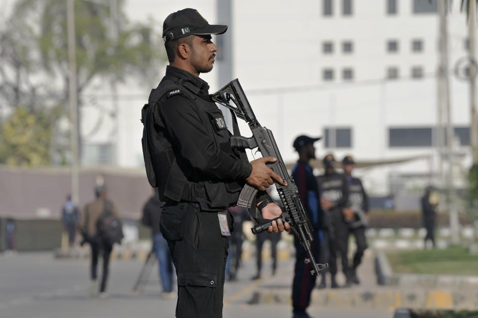 Police commandos stand guard to ensure security at outside the National stadium, where New Zealand cricket team attend a training session, in Karachi, Pakistan, Friday, Dec. 23, 2022. (AP Photo/Fareed Khan)