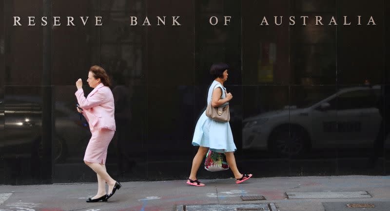 FILE PHOTO: Two women walk next to the Reserve Bank of Australia headquarters in central Sydney