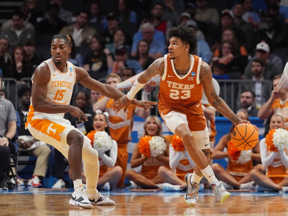 Texas forward Dillon Mitchell, right, dribbles the ball against Tennessee guard Jahmai Mashack in a second-round NCAA Tournament game at Spectrum Center in Charlotte, N.C. Tennessee held on for a 62-58 win to advance to the Sweet Sixteen