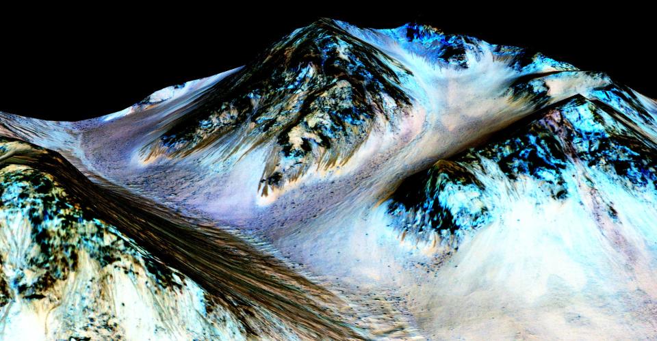 File: Nasa’s Mars Reconnaissance Orbiter handout shows dark, narrow streaks on the slopes of Hale Crater (Getty Images)