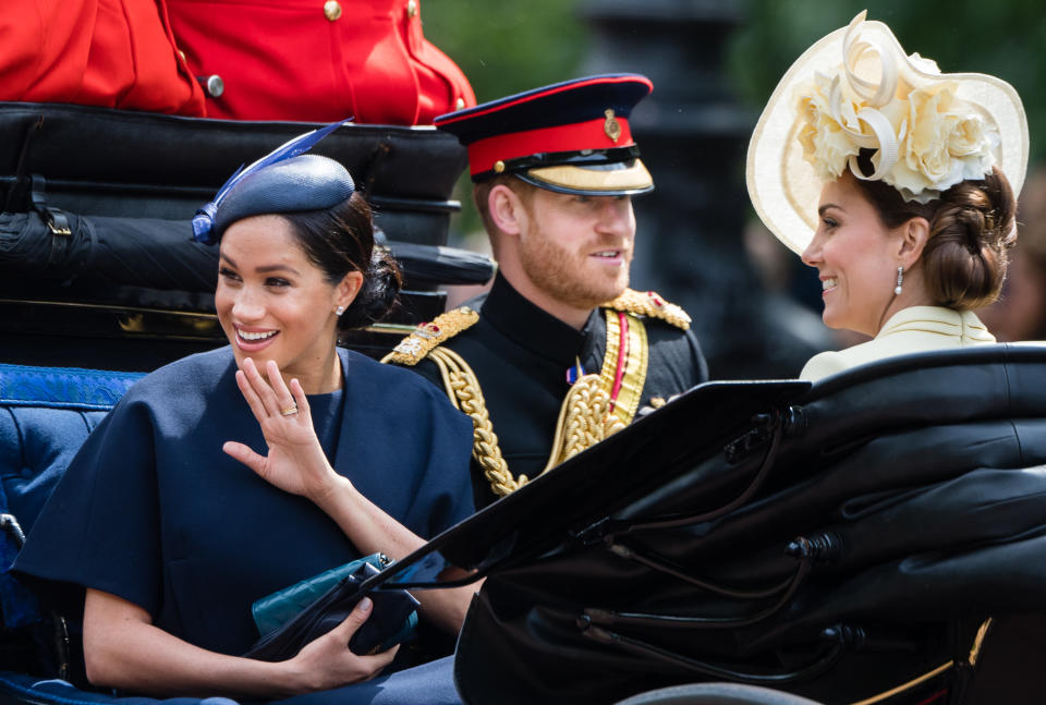 Prince Harry, the Duchess of Sussex and the Duchess of Cambridge ride by carriage down the Mall during Trooping The Colour. [Photo: Getty[