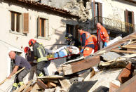 <p>A man is carried on a stretcher after being rescued following an earthquake in Arquata del Tronto, Italy, Wednesday, Aug. 24, 2016. (AP Photo/Sandro Perozzi) </p>