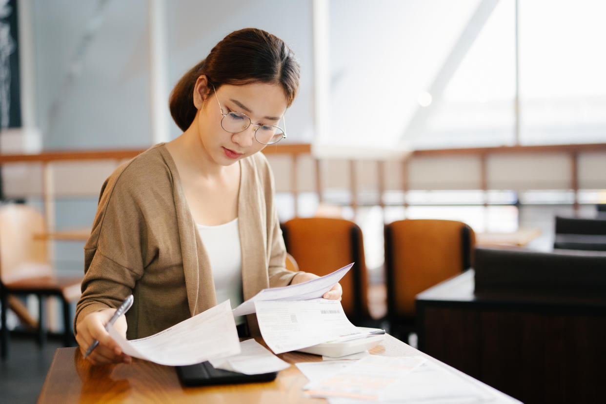 Woman going through household expenses