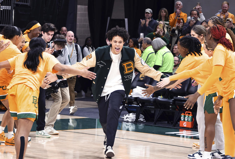 FILE - Former Baylor University legend and WNBA star Brittney Griner runs onto the court during her No. 42 jersey retirement ceremony before an NCAA college basketball game against Texas Tech, Sunday, Feb. 18, 2024, in Waco, Texas. A’ja Wilson, Breanna Stewart and Brittney Griner will be back on the courts chasing another WNBA title when camps open on Sunday, April 28. (Rod Aydelotte/Waco Tribune-Herald via AP, File)