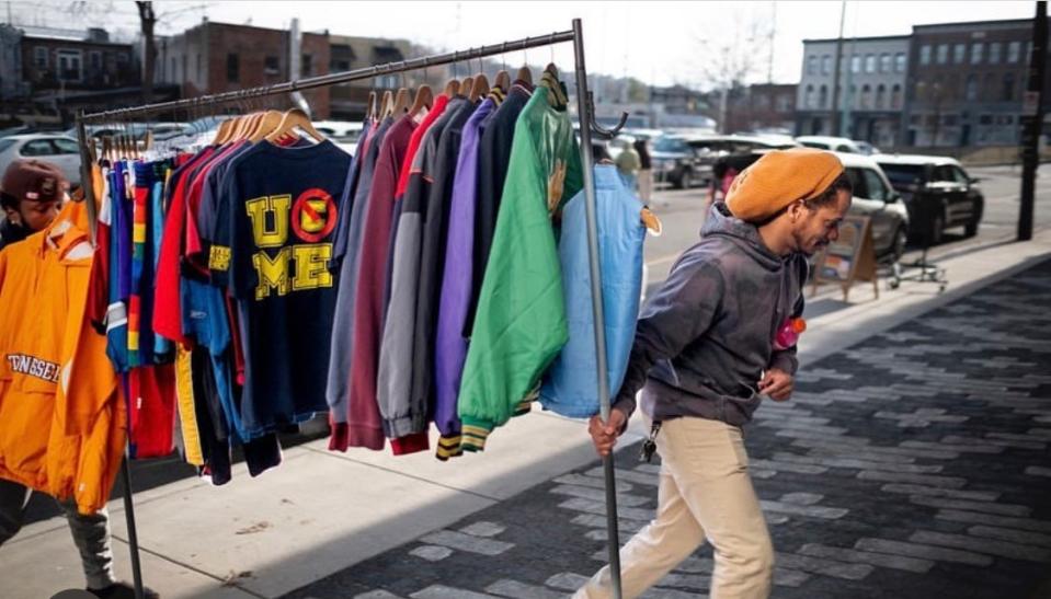 Ricky Hopkins hustles a rack of vintage clothing toward the Old City Performing Arts Center where he and his staff at Past Around presented the Knoxville Vintage Market.