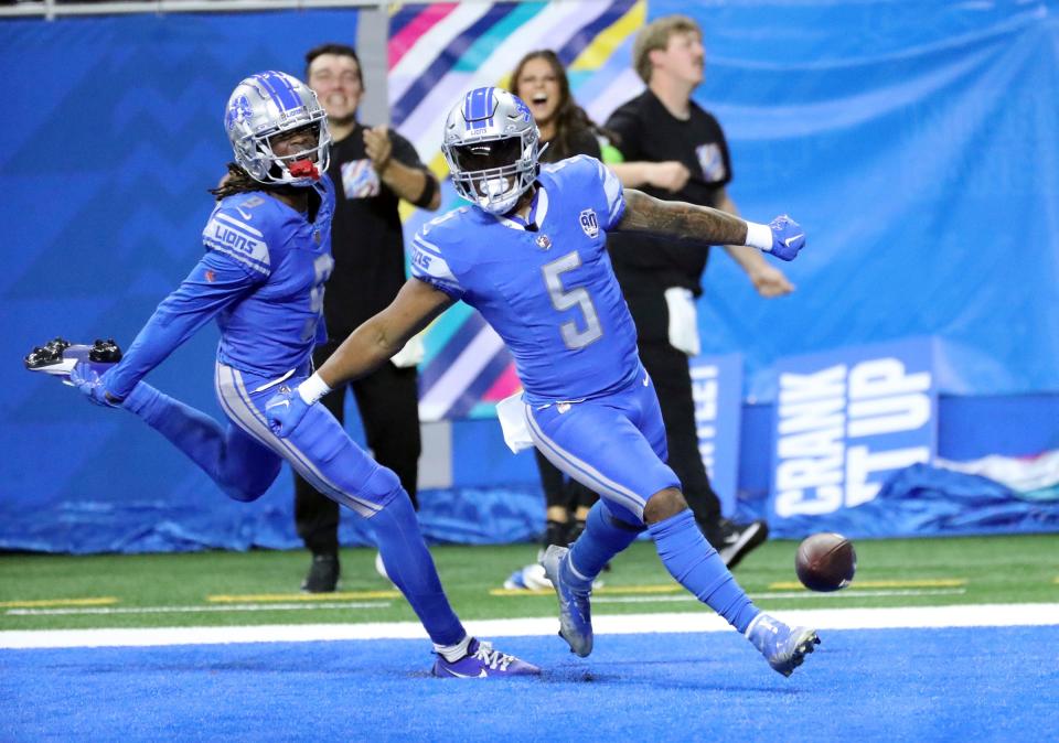 Lions wide receiver Jameson Williams celebrates with running back David Montgomery after Montgomery's touchdown against the Panthers during the first half of the Lions' 42-24 win on Sunday, Oct. 6 2023, at Ford Field.