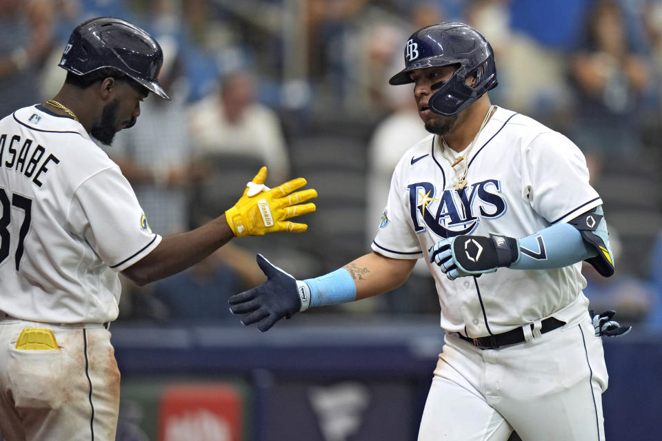 Tampa Bay Rays' Isaac Paredes, right, celebrates with Osleivis Basabe after Paredes hit a solo home run off Colorado Rockies relief pitcher Tommy Doyle during the sixth inning of a baseball game Thursday, Aug. 24, 2023, in St. Petersburg, Fla. (AP Photo/Chris O'Meara)