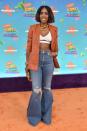<p>In a white crop top, leather blazer and distressed jeans with hidden heels at the 2023 Nickelodeon Kids Choice Awards at Microsoft Theater in Los Angeles, Calif. on March 4, 2023.</p>