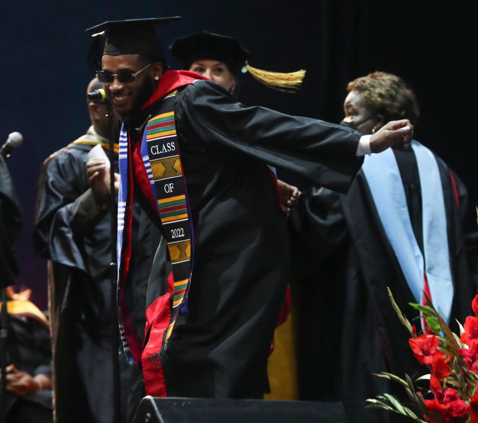 Graduate Kavante Dawson dances as he receives his diploma during Delaware State University's 2022 commencement ceremonies in Memorial Hall, Saturday, May 14, 2022.