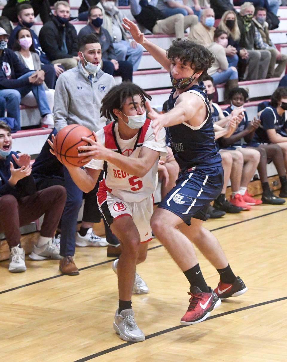 JJ Martin of Barnstable attempts to pass under tight pressure from Emir Polat of Cape Cod Academy in this December 2021 game.
(Photo: Ron Schloerb/Cape Cod Times)