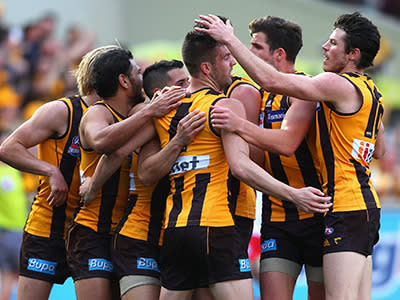 <p>Matt Suckling is mobbed by Hawthorn teammates after kicking a goal.</p>