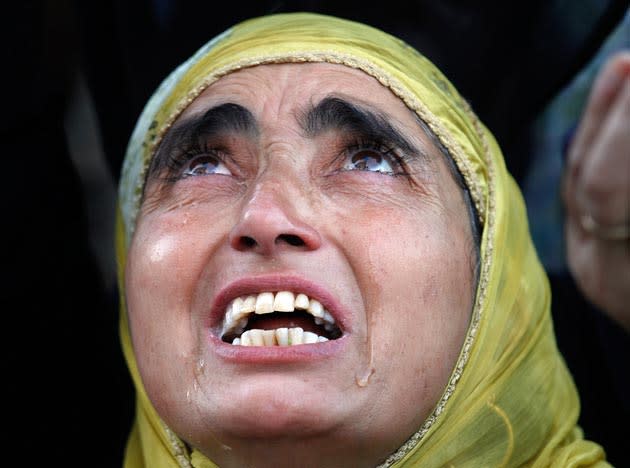 Tears roll down the cheeks of a Kashmiri Muslim woman as the head priest, unseen, displays the holy relic believed to be a hair from the beard of Prophet Mohammad, during special prayers to observe the Martyr Day of Hazrat Ali, cousin of Prophet Mohammed, on the 21st day of Ramadan at the Hazratbal Shrine in Srinagar, India, Wednesday, Sept. 1, 2010. Muslims across the world are observing the holy fasting month of Ramadan, where devout refrain from eating, drinking and smoking from dawn to dusk. (AP Photo/Dar Yasin)