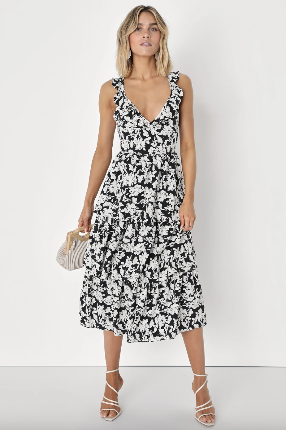 blonde model wearing black and white Elated Elegance Black Floral Print Ruffled Tiered Midi Dress (photo via Lulus)