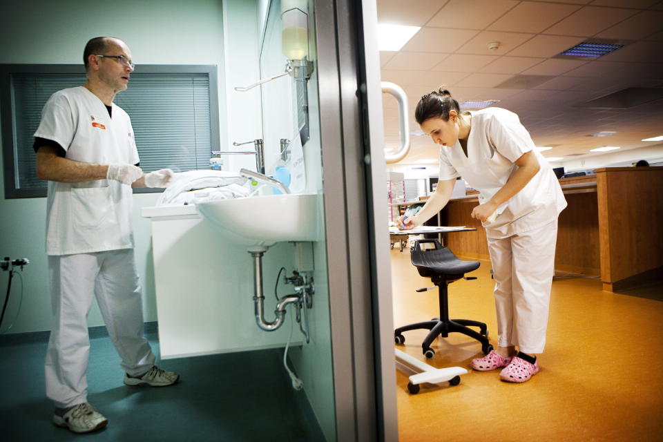 Reportage in Robert Ballanger hospital's Intensive Care Unit in France. A nursing auxiliary and a student nurse get ready to deal with a patient. (Photo by: BSIP/Universal Images Group via Getty Images)
