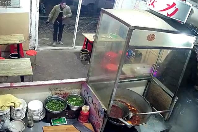 Restaurant's glass door shatters after man walks straight into it in central China