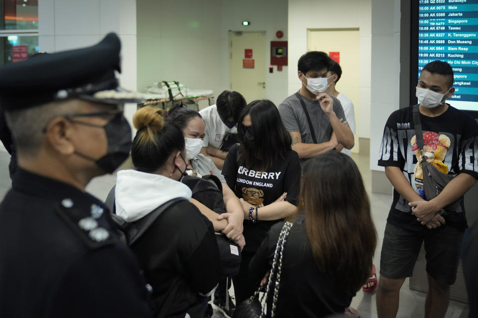 Malaysian youths rescued from human traffickers in Cambodia arrive at the Kuala Lumpur Airport Terminal in Sepang, Thursday, Oct. 6, 2022. Another 21 Malaysians rescued from human traffickers in Cambodia and Laos returned to the country Thursday, as the government intensified effort to detect scam victims stranded abroad. (AP Photo/Vincent Thian)