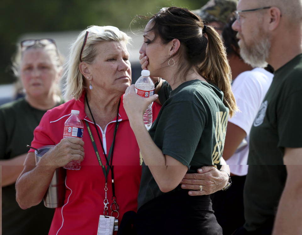 <p>Santa Fe High School staff react as they gather in the parking lot of a gas station following a shooting at the school in Santa Fe, Texas, on Friday, May 18, 2018. (Photo: Jennifer Reynolds/The Galveston County Daily News via AP) </p>