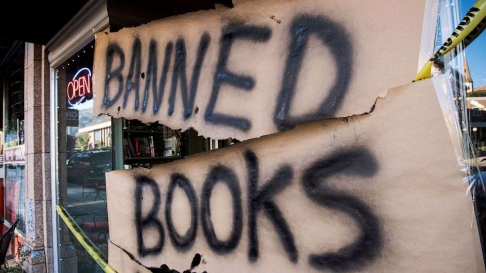 A sign wrapped in caution tape reading "Banned Books Week" is displayed at Main Street Books bookstore during Banned Books Week, on Sept. 26, 2018 in Cedar City, Utah.