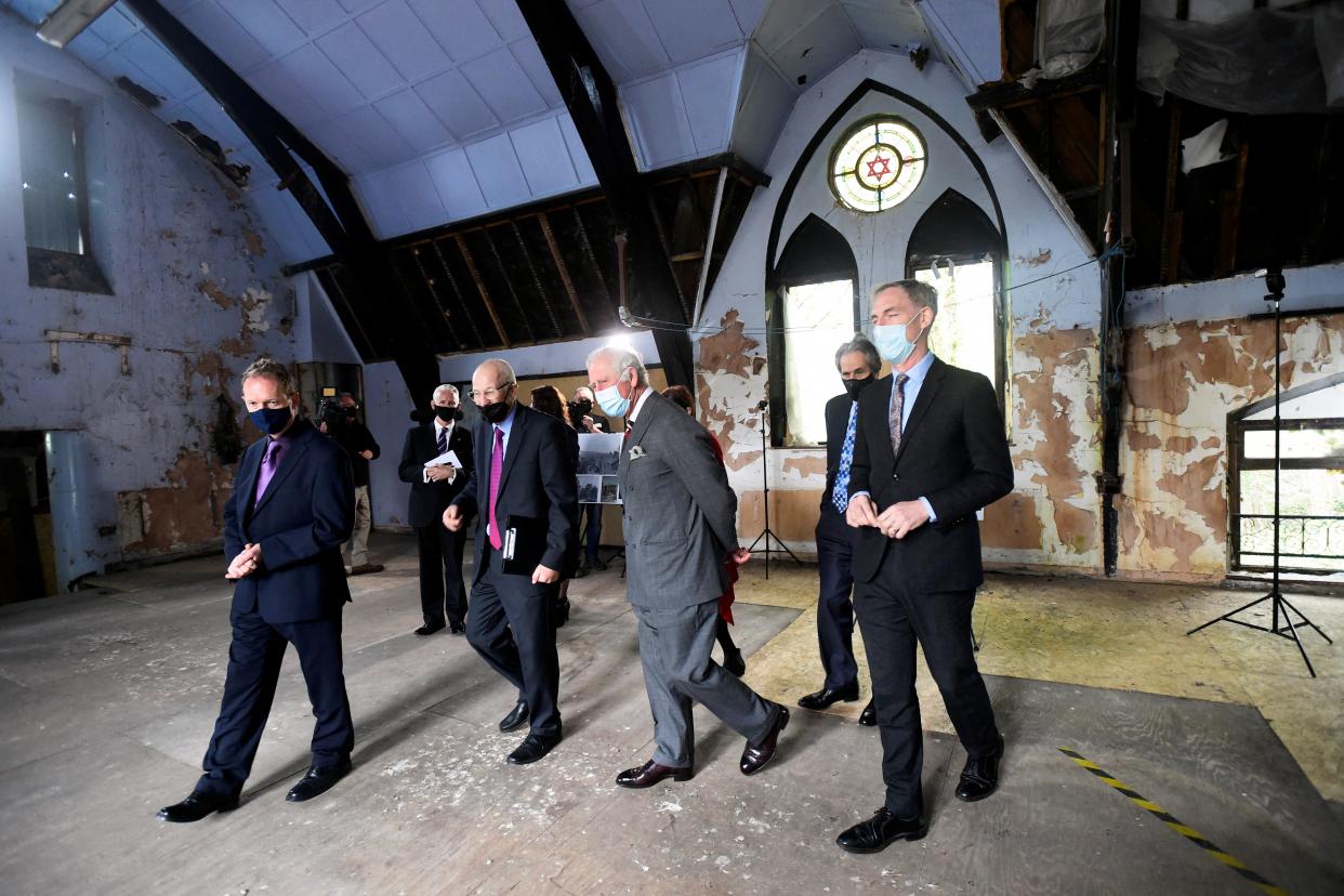 Britain's Prince Charles, Prince of Wales (C), wearing a face covering due to Covid-19, visits the former Merthyr Tydfil Synagogue in Merthyr Tydfil, on May 14, 2021, during his day-long visit to Wales. (Photo by REBECCA NADEN / POOL / AFP) (Photo by REBECCA NADEN/POOL/AFP via Getty Images)