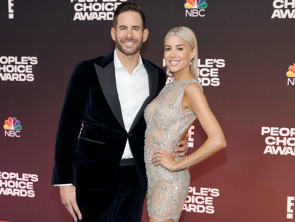 Tarek El Moussa and Heather Rae El Moussa on a red carpet.