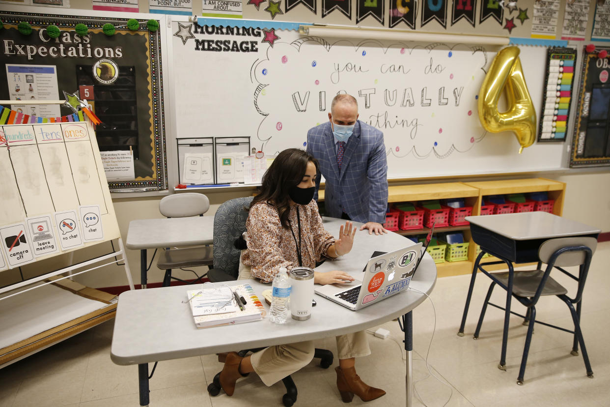 Superintendent Matt Malone watches fourth-grade teacher Amber Moukhtarian instruct her students via Zoom at Mary L. Fonseca Elementary School in Massachusetts.