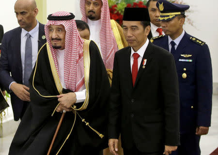 Saudi Arabia's King Salman walks with Indonesian President Joko Widodo during their meeting at the Presidential Palace in Bogor, West Java, Indonesia March 1, 2017. REUTERS/Achmad Ibrahim