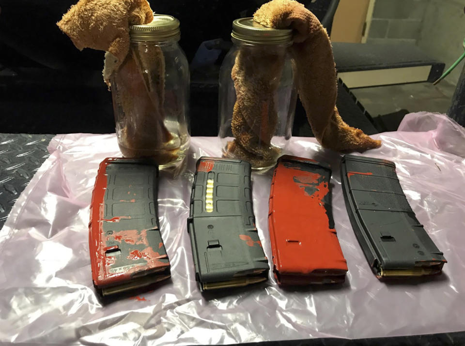 This photo posted Sunday, July 26, 2020, by the Portland Police Department on their Twitter page shows items the police say were loaded rifle magazines and Molotov cocktails found at a park in Portland, Oregon. A bag containing loaded rifle magazines and Molotov cocktails was found at Lownsdale Square Park near where protests have erupted for two months in Portland, following the death of George Floyd, police said. The photo of the items was shared in a tweet from police late Sunday saying someone pointed out the bag to officers at park late Sunday. No further information was immediately released.(Portland Police Department via AP)
