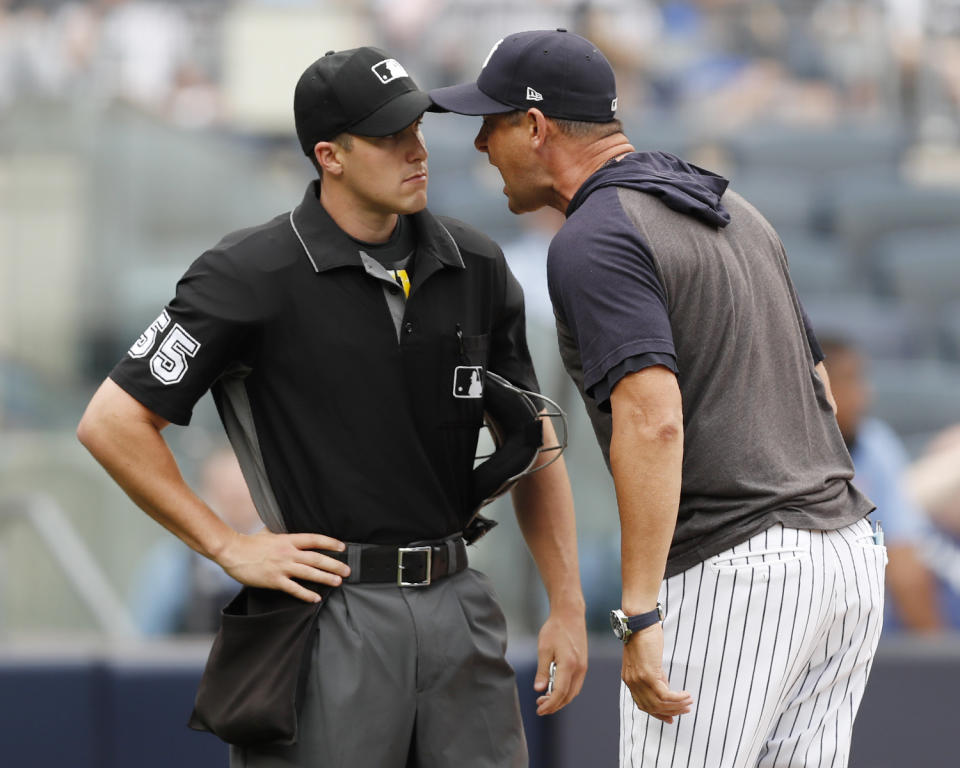 New York Yankees' Aaron Boone, right, gets in the face of home plate umpire Brennan Miller during the second inning of game one of a baseball doubleheader against the Tampa Bay Rays, Tuesday, July 16, 2019, in New York. Boone had already been ejected when he expressed his displeasure with the umpire's calls. (AP Photo/Kathy Willens)