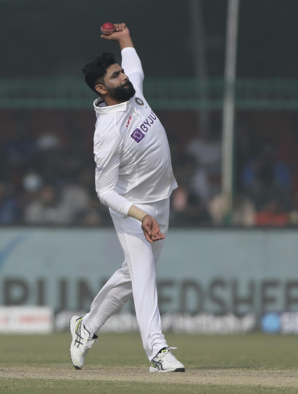 India's Ravindra Jadeja bowls during the day three of their first test cricket match with New Zealand in Kanpur, India, Saturday, Nov. 27, 2021. (AP Photo/Altaf Qadri)