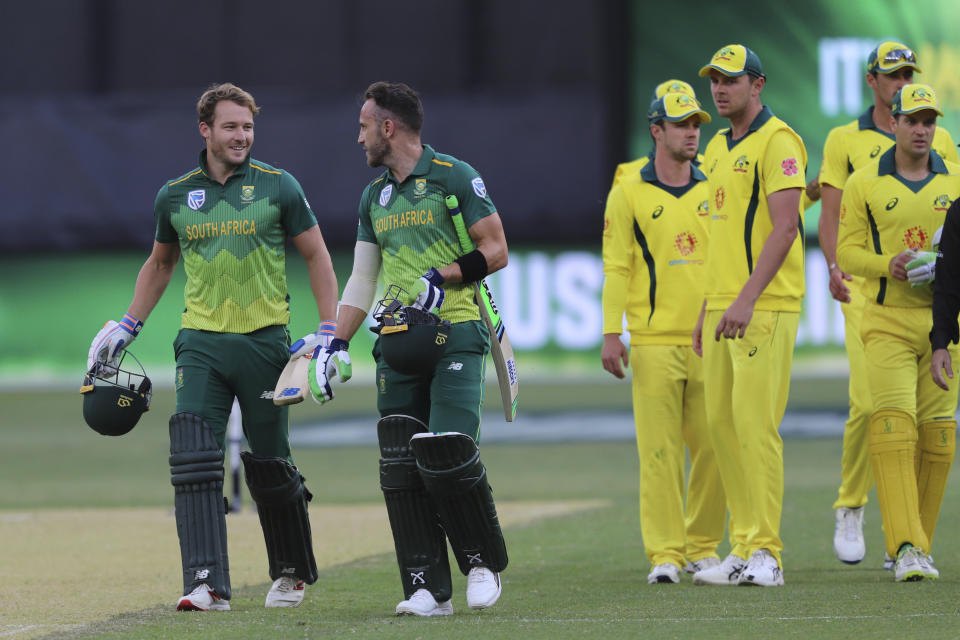 South Africa's David Miller (left) and Faf du Plessis, second left, leave the pitch after defeating Australia in their one-day international cricket match in Perth, Sunday, Nov. 4, 2018. (AP Photo/Trevor Collens)