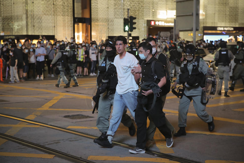 Police detained a man during a protest marking the first anniversary of a mass rally against the now-withdrawn extradition bill in Hong Kong, Tuesday, June 9, 2020. One year ago, a sea of humanity a million people by some estimates marched through central Hong Kong on a steamy afternoon. It was the start of what would grow into the longest-lasting and most violent anti-government movement the city has seen since its return to China in 1997. (AP Photo/Kin Cheung)