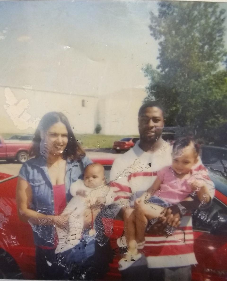 Cynthia Shouse, left, and Ishmael Abram, right, pose for a photo while holding their two daughters outside a Red Lobster restaurant on Mother's Day in 2000.