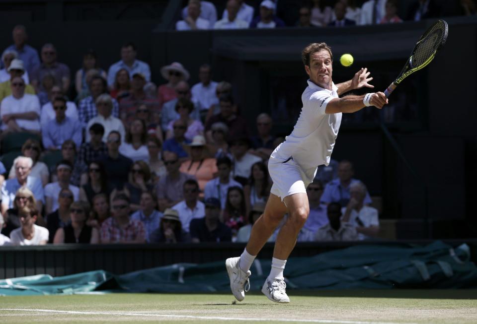 Richard Gasquet of France hits a shot during his match against Novak Djokovic of Serbia at the Wimbledon Tennis Championships in London, July 10, 2015. REUTERS/Adrian Dennis/Pool