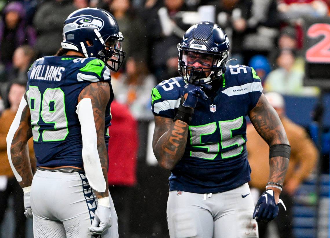 Seattle Seahawks defensive end Dre’Mont Jones (55) reacts to a hit on Washington Commanders quarterback Sam Howell (14) during the third quarter of the game at Lumen Field, on Sunday, Nov. 12, 2023, in Seattle, Wash. Brian Hayes/bhayes@thenewstribune.com