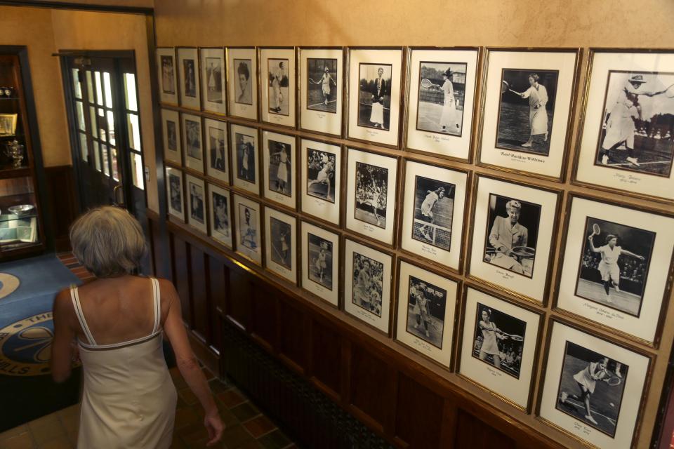 In this Tuesday, July 2, 2013 photo, pictures of tennis champions line the walls at the West Side Tennis Club in the Queens section of New York. The Beatles. The Rolling Stones. Frank Sinatra. Jimi Hendrix. Bob Dylan. They’ve all held court at the more than century-old West Side Tennis Club in Queens’ Forest Hills neighborhood - for six decades the site of the U.S. Open Tennis Championships. Plans are now in the works for the grassy lawn to come alive again with the sound of music, starting with a concert featuring the British band Mumford & Sons, to be followed by a lineup of world-class musicians. (AP Photo/Seth Wenig)