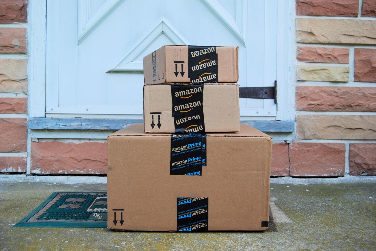 Amazon packages waiting on a home's doorstep. (Photo: Getty)