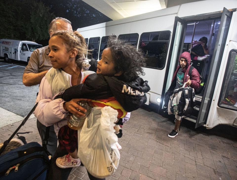 Families of asylum seekers are led into the Ramada hotel in Yonkers May 15, 2023. The families were being housed in New York City.